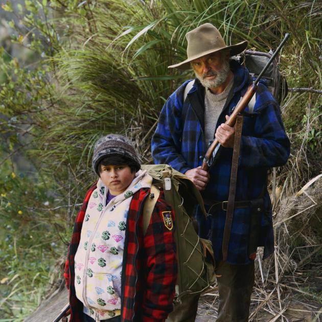 Man and young boy hiking on mountain