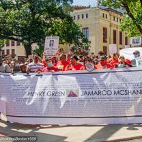 People marching with big banner