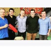 Six white men posing in a line with musical instruments