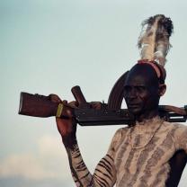 Photos of indigenous man with rifle 