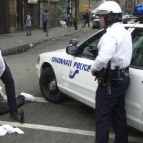 Two Cincinnati police with black man on ground in handcuffs